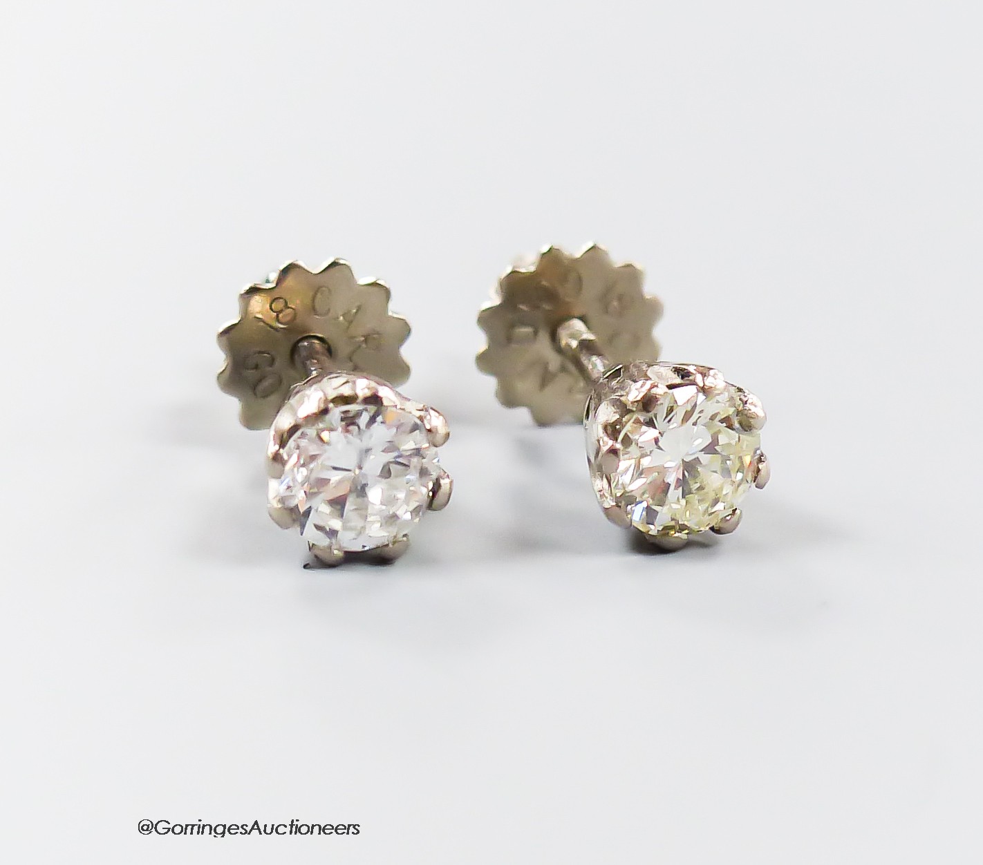 A pair of modern 18ct and solitaire diamond set ear studs, the stones each weighing approximately 0.30ct, gross weight 1.6 grams.